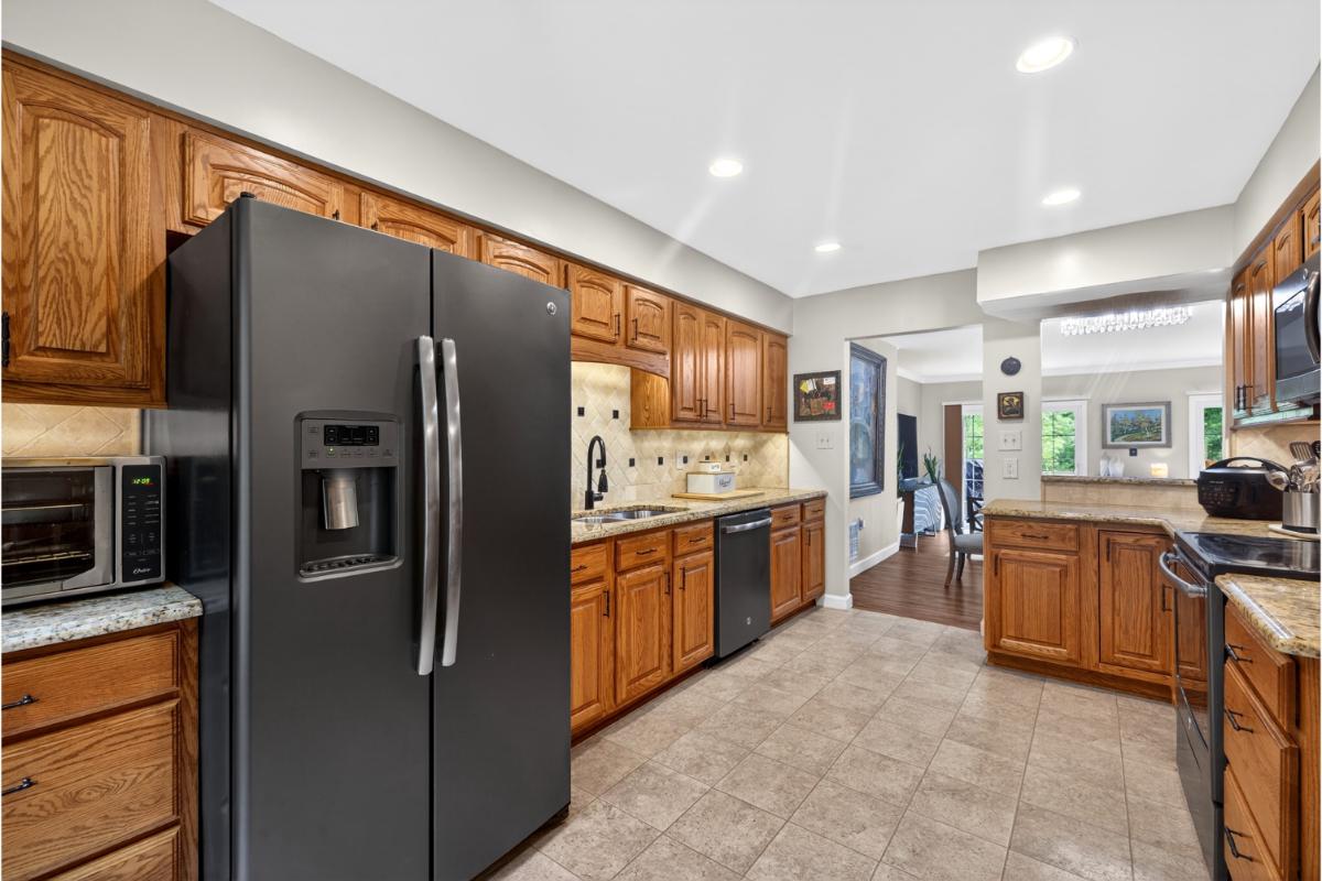 7347 Swan Point Way, Unit 122 Columbia, MD 21045 - Photo 15 of 54 a kitchen with stainless steel appliances granite countertop a refrigerator a stove top oven and sink