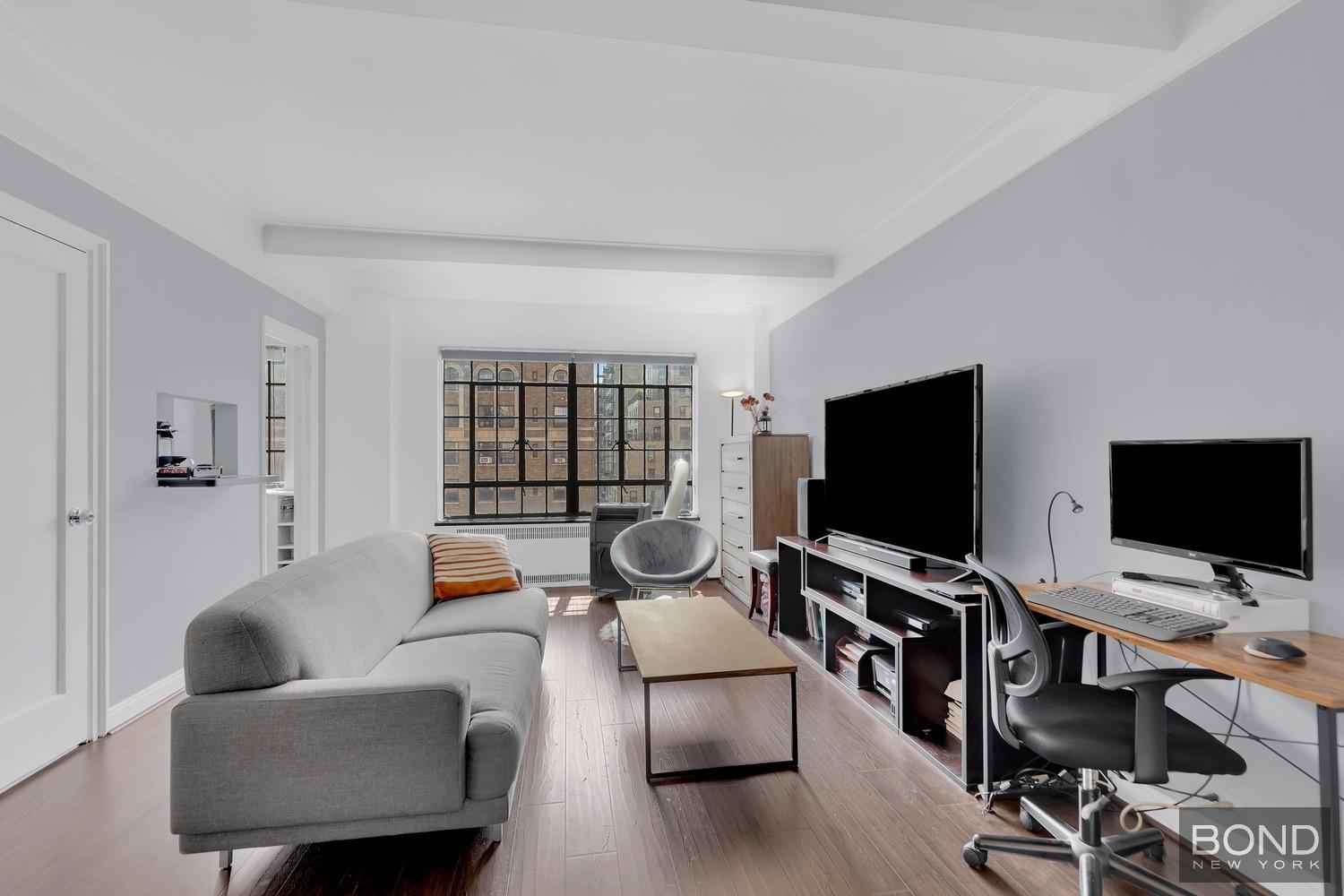 10 Park Avenue, Unit 14H Manhattan, NY 10016 - Photo 2 of 14 a living room with furniture and a flat screen tv