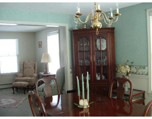 10 Vermont Road Tyngsborough, MA 01879 - Photo 6 of 19 a living room with furniture a chandelier and a window