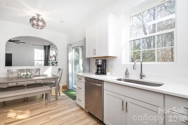 a kitchen with a sink cabinets and window