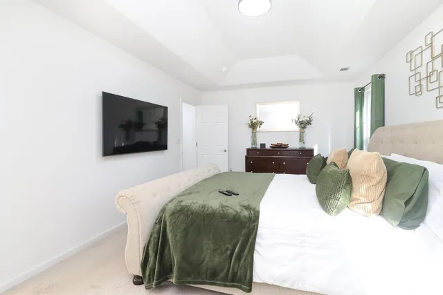 a bedroom with a bed and a television