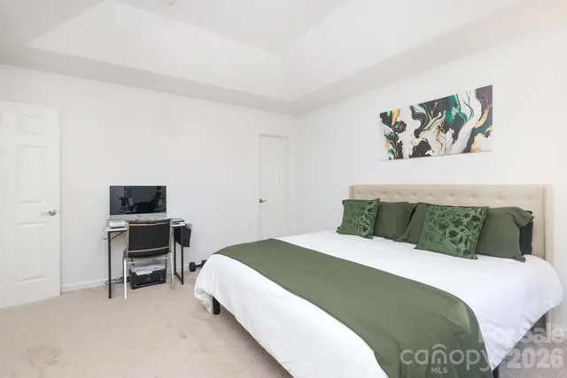 a bedroom with a bed and a desk