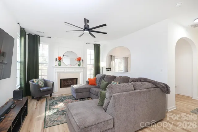 a living room with furniture and a fireplace