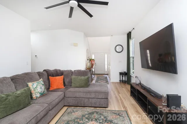a living room with furniture and a flat screen tv