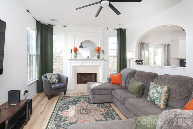 a living room with furniture and a fireplace