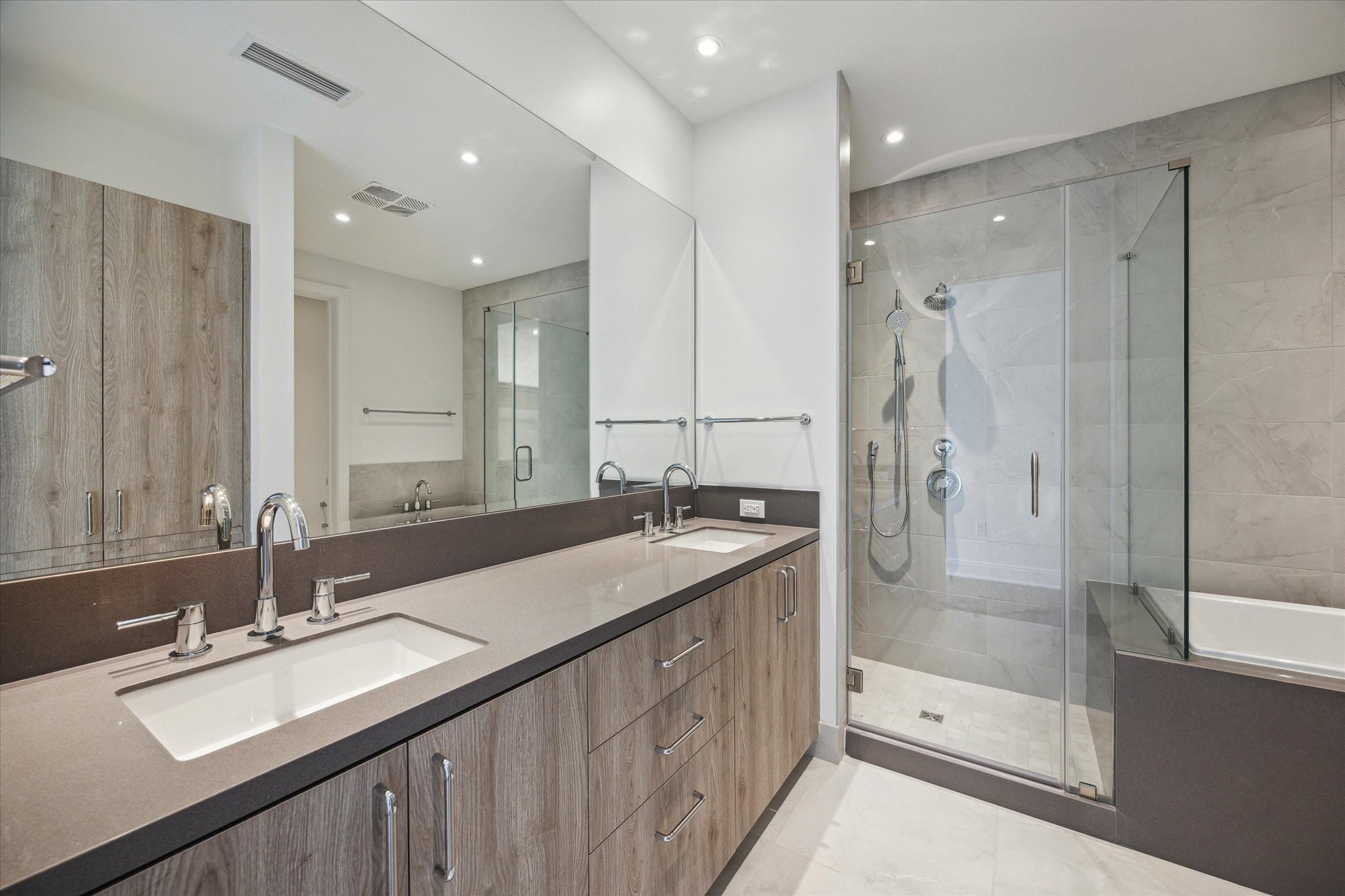 2323 West Main Street, Unit 603 Houston, TX 77098 - Photo 11 of 18 a bathroom with double vanity sinks and a shower