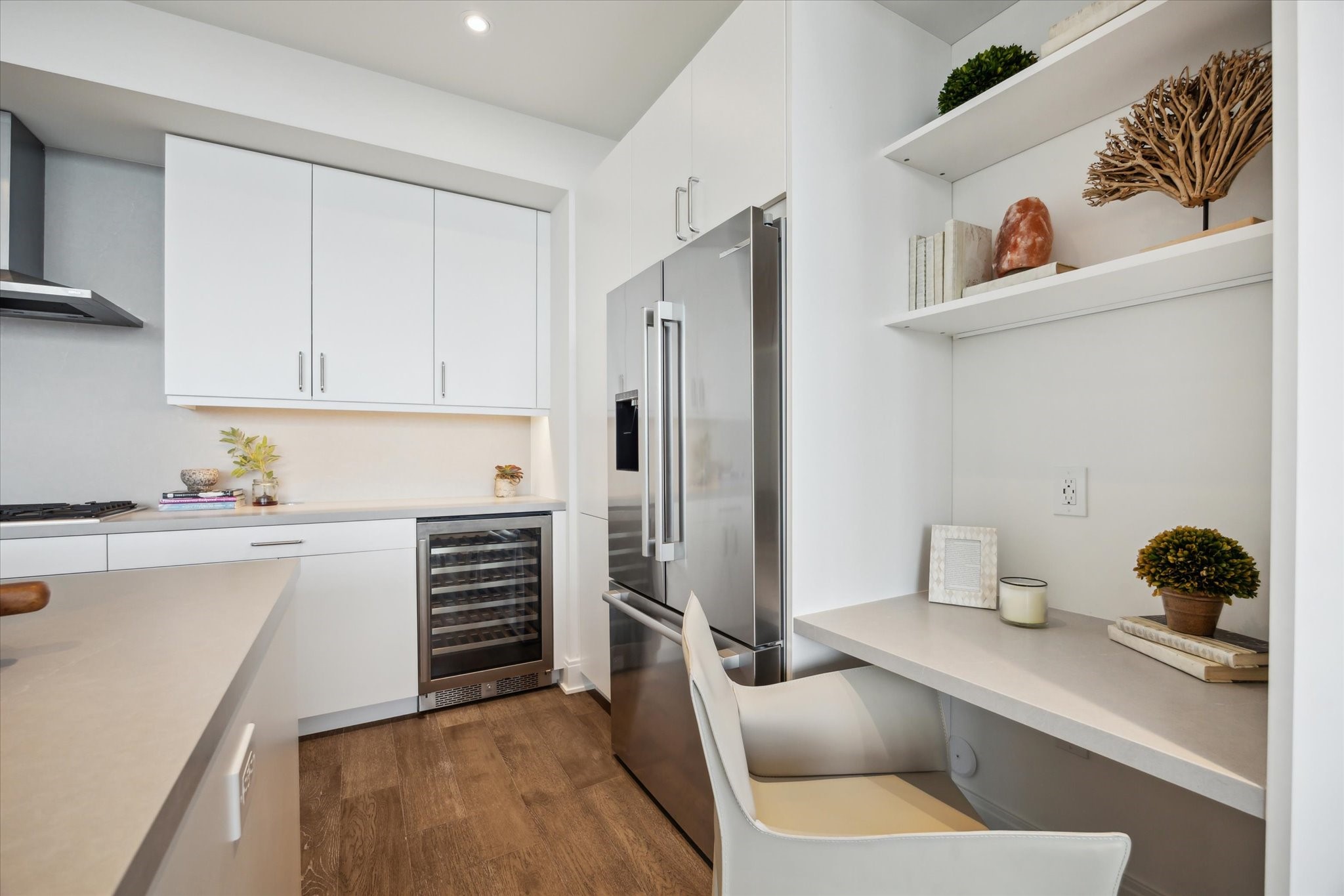 2323 West Main Street, Unit 603 Houston, TX 77098 - Photo 4 of 18 a kitchen with a refrigerator and white cabinets
