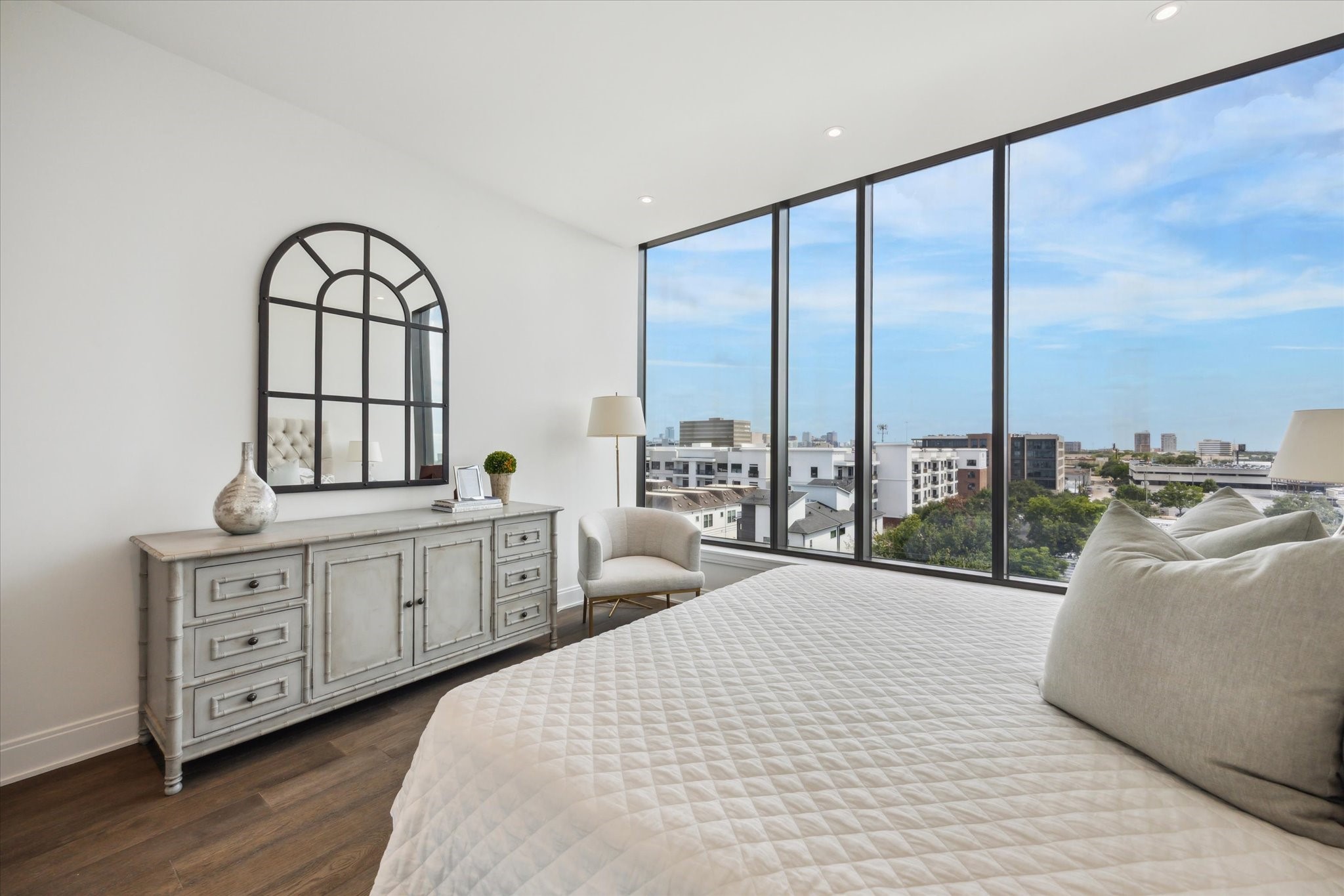 2323 West Main Street, Unit 603 Houston, TX 77098 - Photo 9 of 18 a spacious bedroom with a large bed and a chandelier