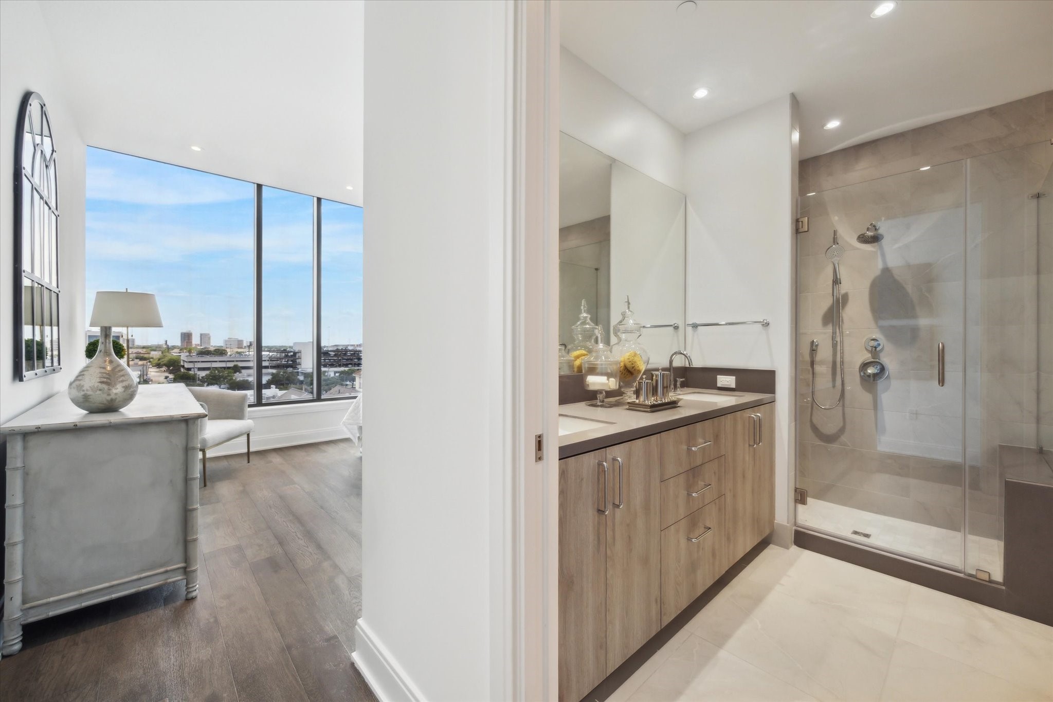 2323 West Main Street, Unit 603 Houston, TX 77098 - Photo 10 of 18 a bathroom with a double vanity sink mirror and shower