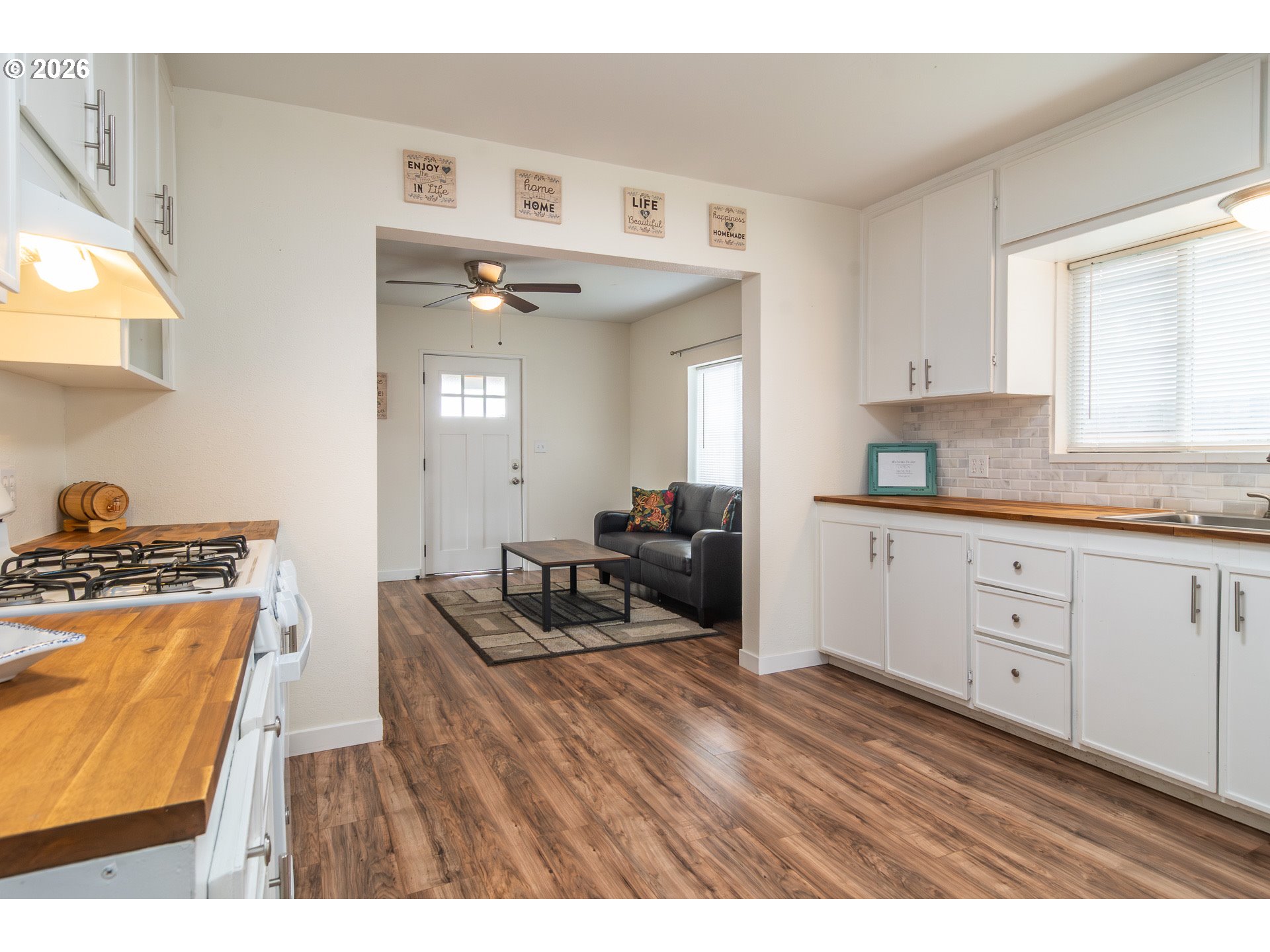 139 South R Street Riddle, OR 97469 - Photo 14 of 33 a kitchen with stainless steel appliances granite countertop a stove a sink and a refrigerator