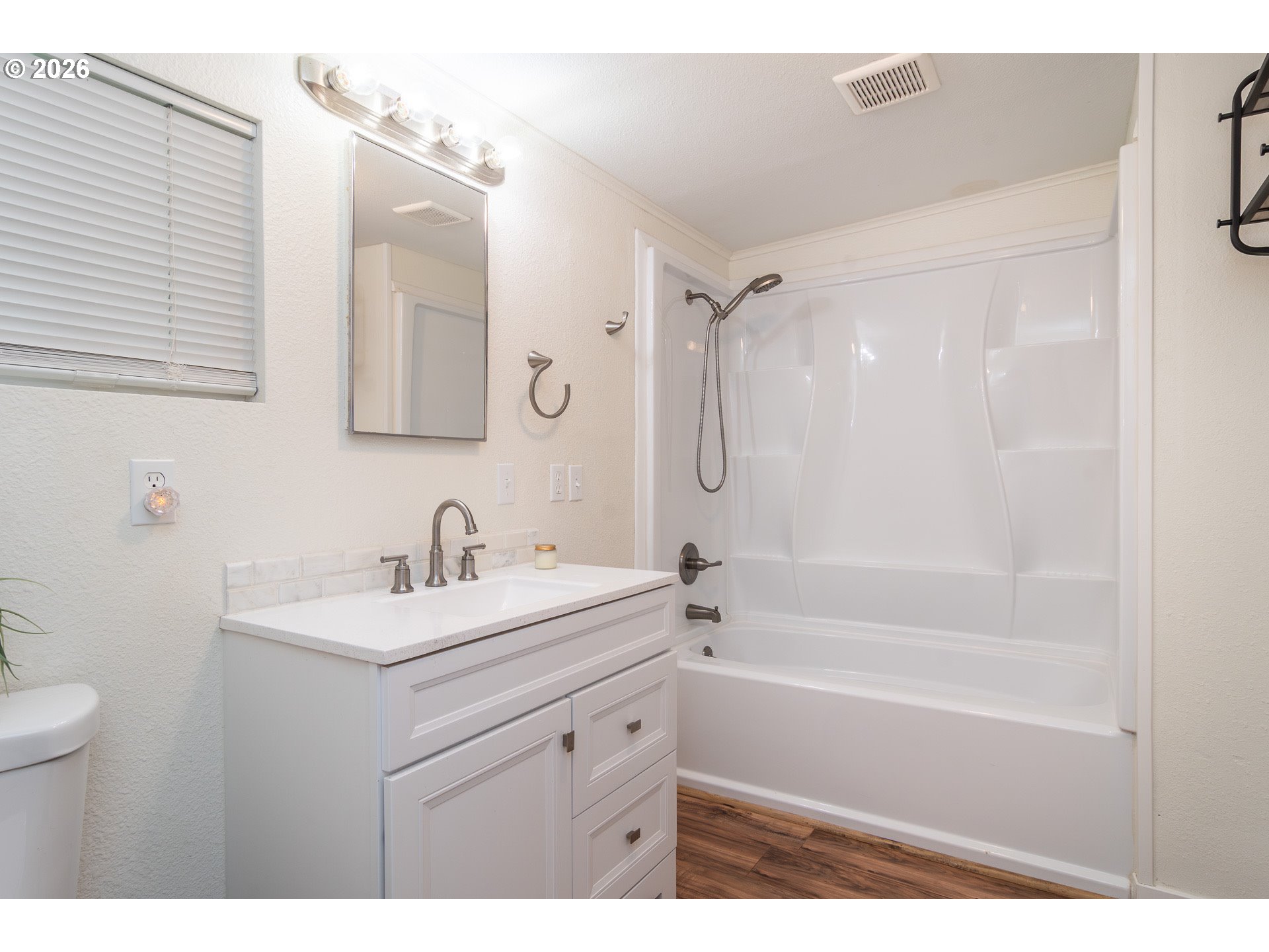 139 South R Street Riddle, OR 97469 - Photo 16 of 33 a bathroom with a sink double vanity mirror and a bathtub