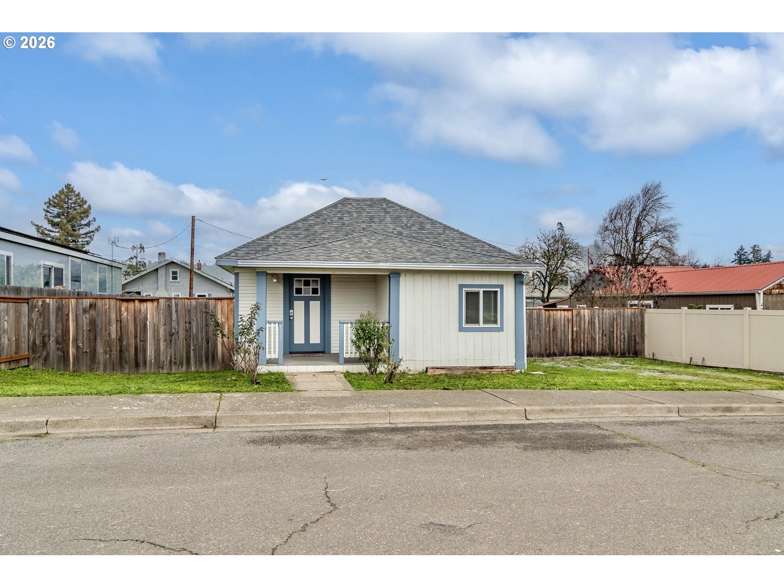 139 South R Street Riddle, OR 97469 - Photo 2 of 33 a front view of a house with a yard and garage