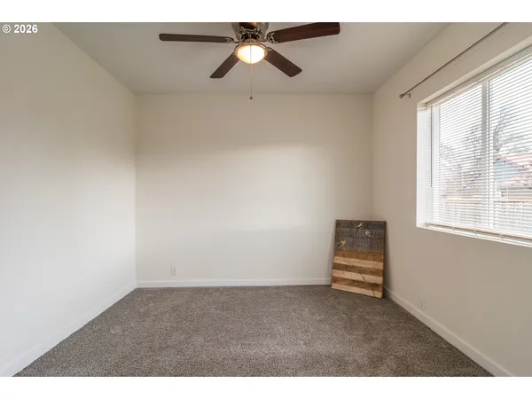 a room with a ceiling fan and a window