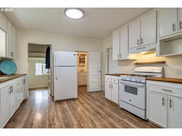 a kitchen with a refrigerator stove and wooden cabinets