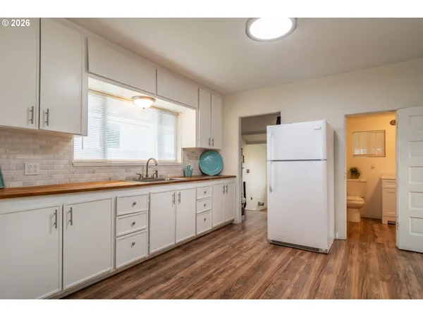a kitchen with sink refrigerator and cabinets