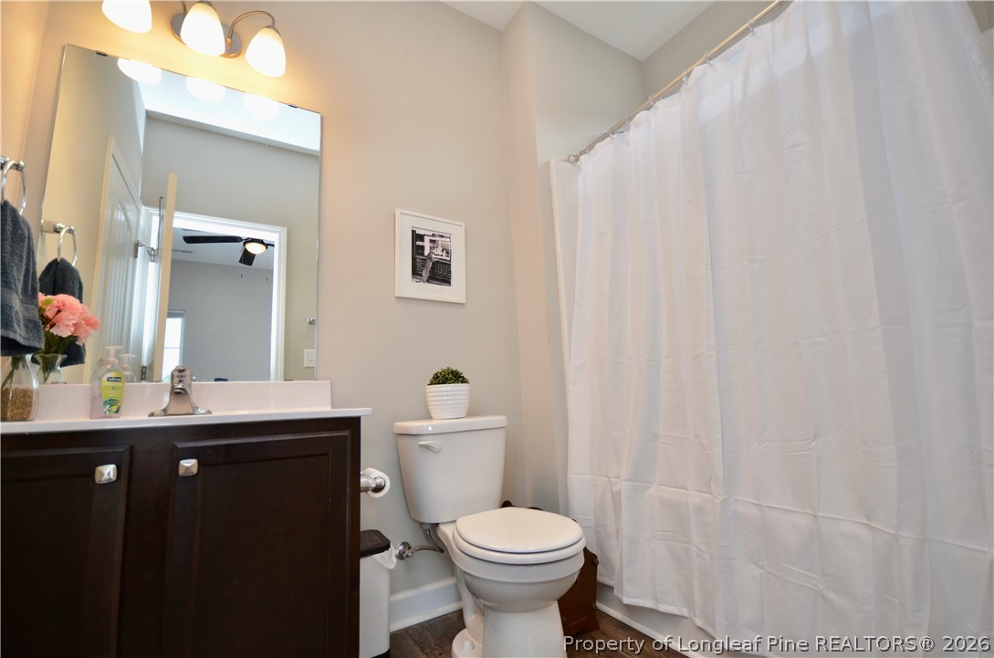 1865 John B Carter Road Fayetteville, NC 28312 - Photo 25 of 49 a bathroom with a toilet sink and mirror