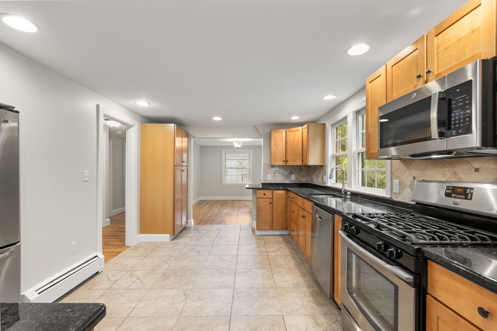 92 Abbot Street Andover, MA 01810 - Photo 9 of 35 a large kitchen with stainless steel appliances granite countertop a stove and a sink