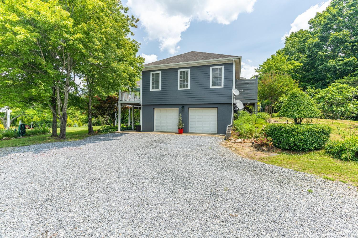 3297 Midway Road Phenix, VA 23959 - Photo 16 of 89 a front view of a house with a yard and garage