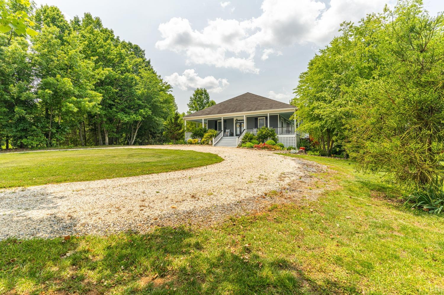 3297 Midway Road Phenix, VA 23959 - Photo 23 of 89 a view of a house with a big yard and potted plants and large tree