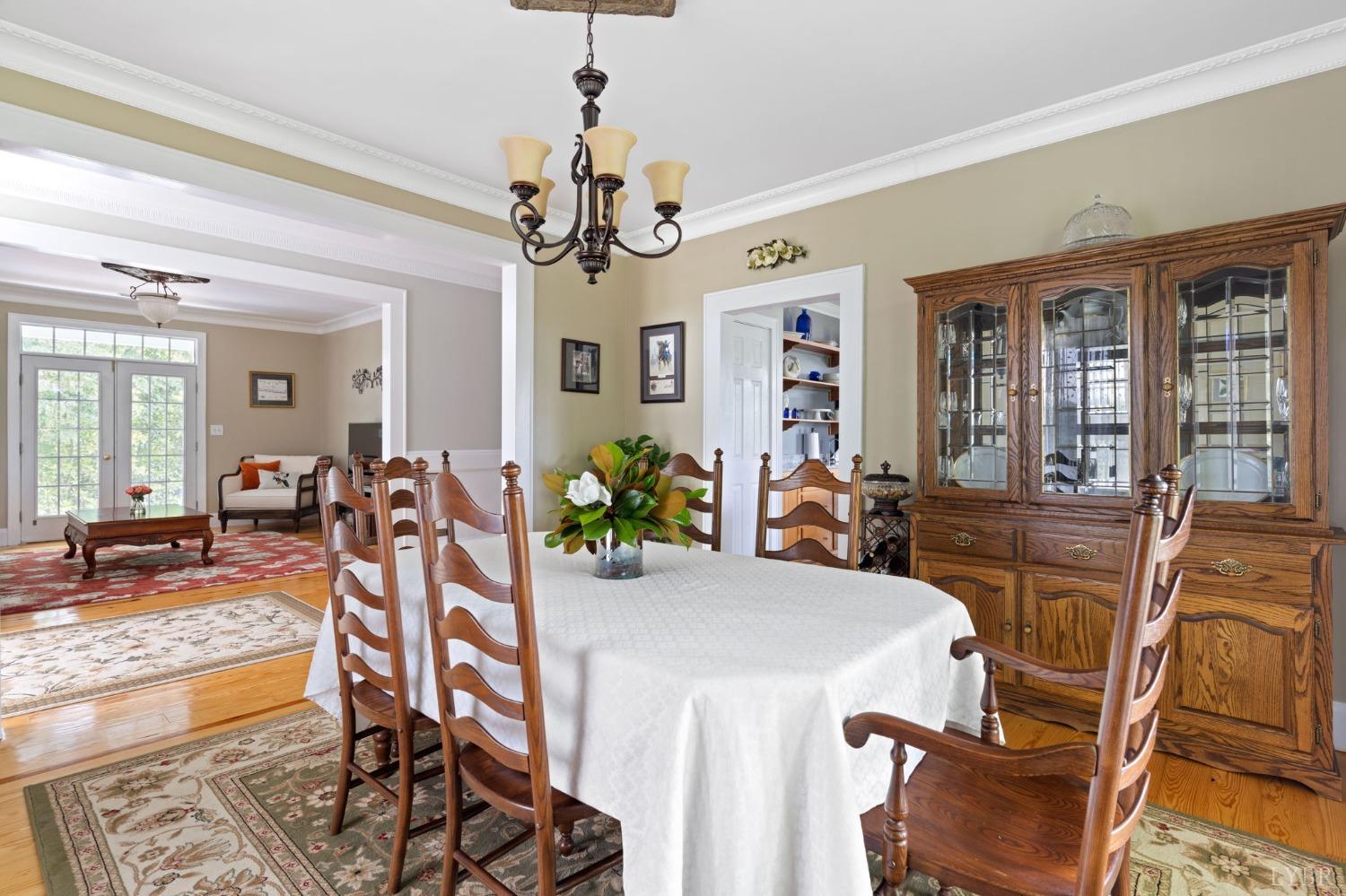 3297 Midway Road Phenix, VA 23959 - Photo 29 of 89 a view of a dining room with furniture a chandelier and wooden floor