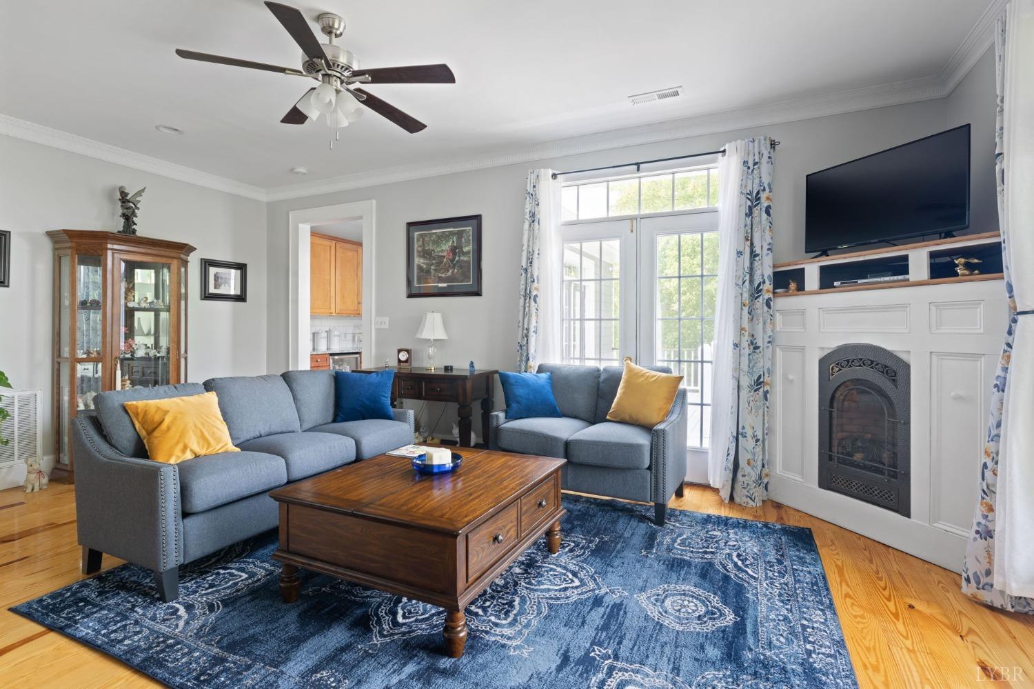 3297 Midway Road Phenix, VA 23959 - Photo 36 of 89 a living room with furniture a flat screen tv and a fireplace