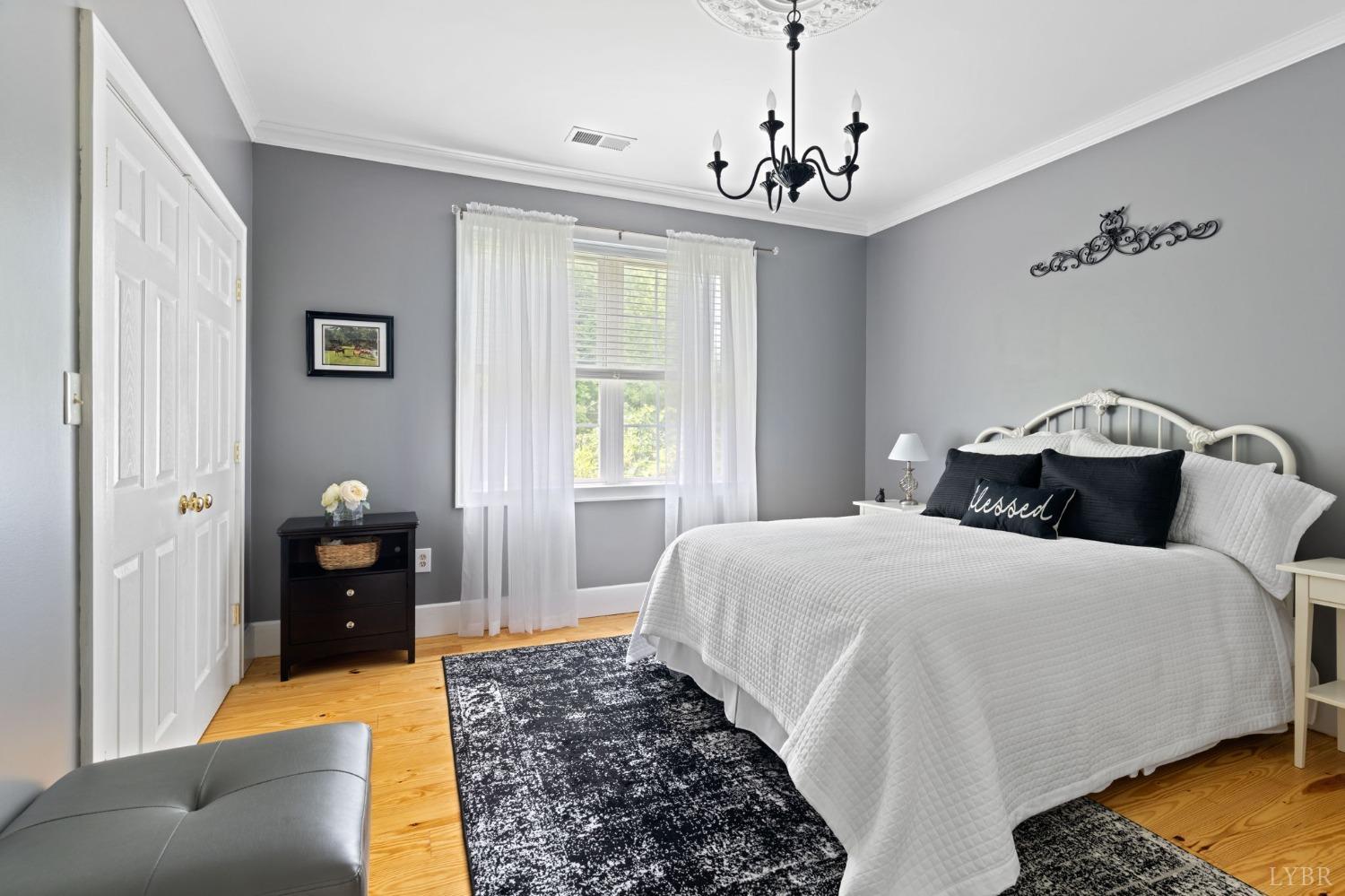 3297 Midway Road Phenix, VA 23959 - Photo 41 of 89 a bedroom with a bed and wooden floor