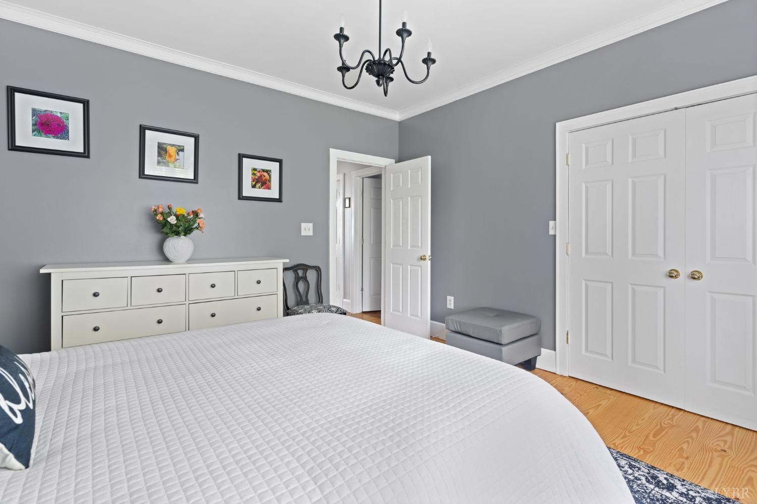 3297 Midway Road Phenix, VA 23959 - Photo 42 of 89 a bedroom with a bed and a chandelier