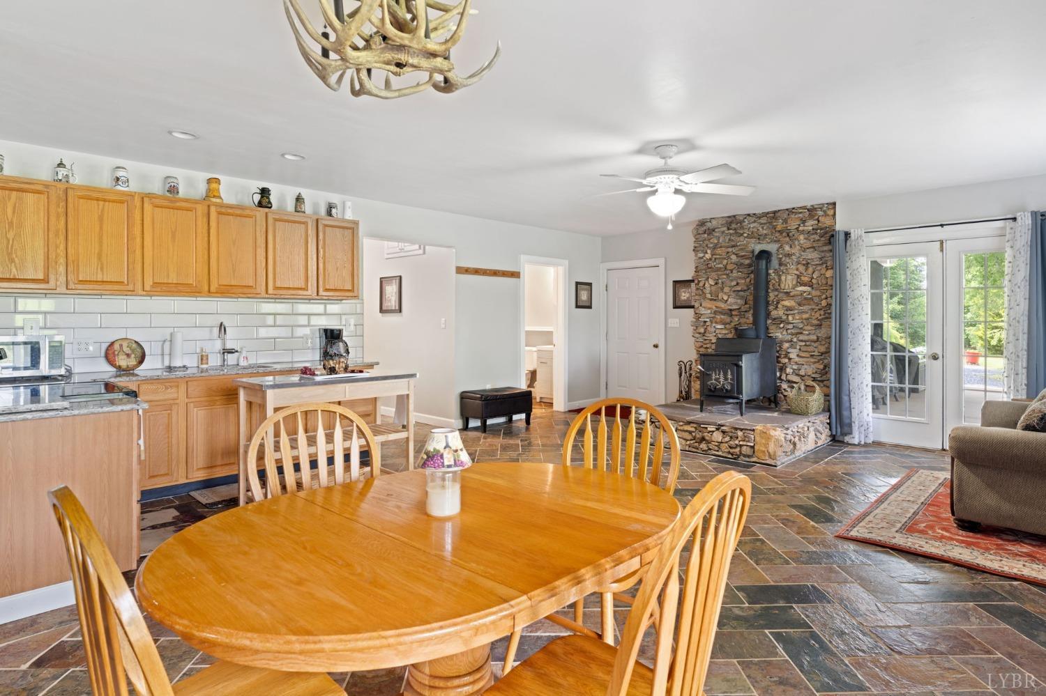 3297 Midway Road Phenix, VA 23959 - Photo 57 of 89 a dining room with furniture a window and wooden floor