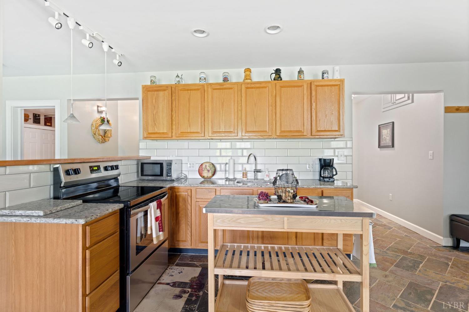 3297 Midway Road Phenix, VA 23959 - Photo 58 of 89 a kitchen with stainless steel appliances a stove a sink and a microwave