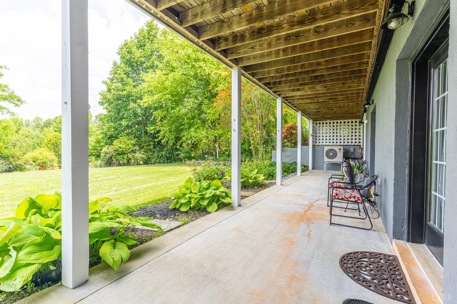 3297 Midway Road Phenix, VA 23959 - Photo 89 of 89 a porch with a table and chairs and potted plants