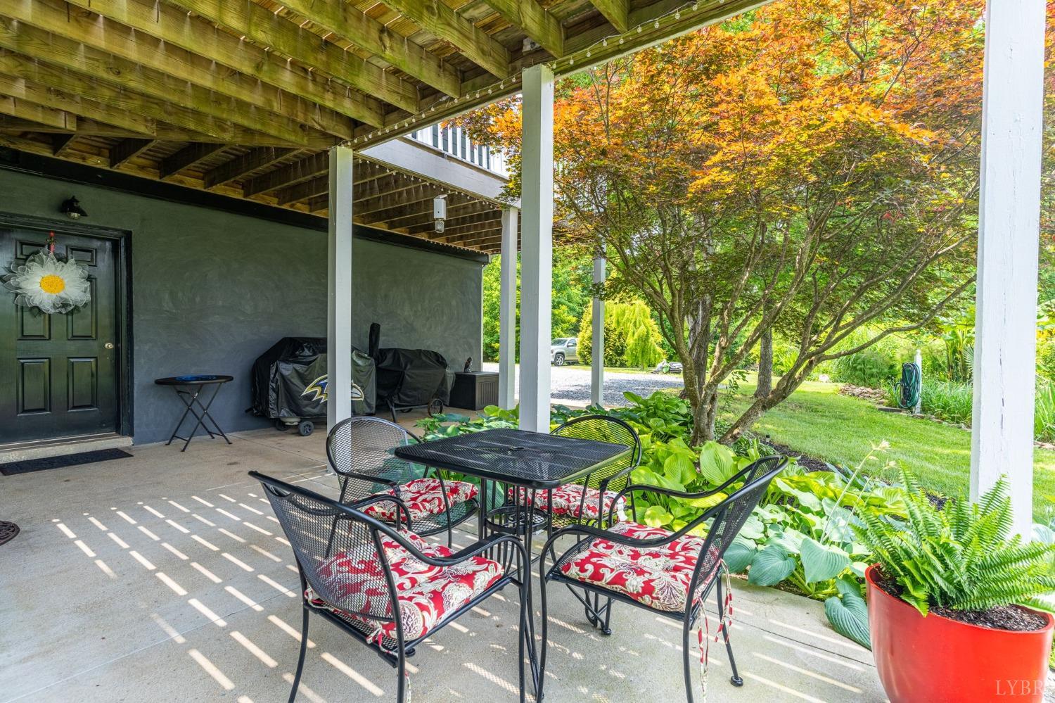 3297 Midway Road Phenix, VA 23959 - Photo 9 of 89 a patio with table and chairs and potted plants