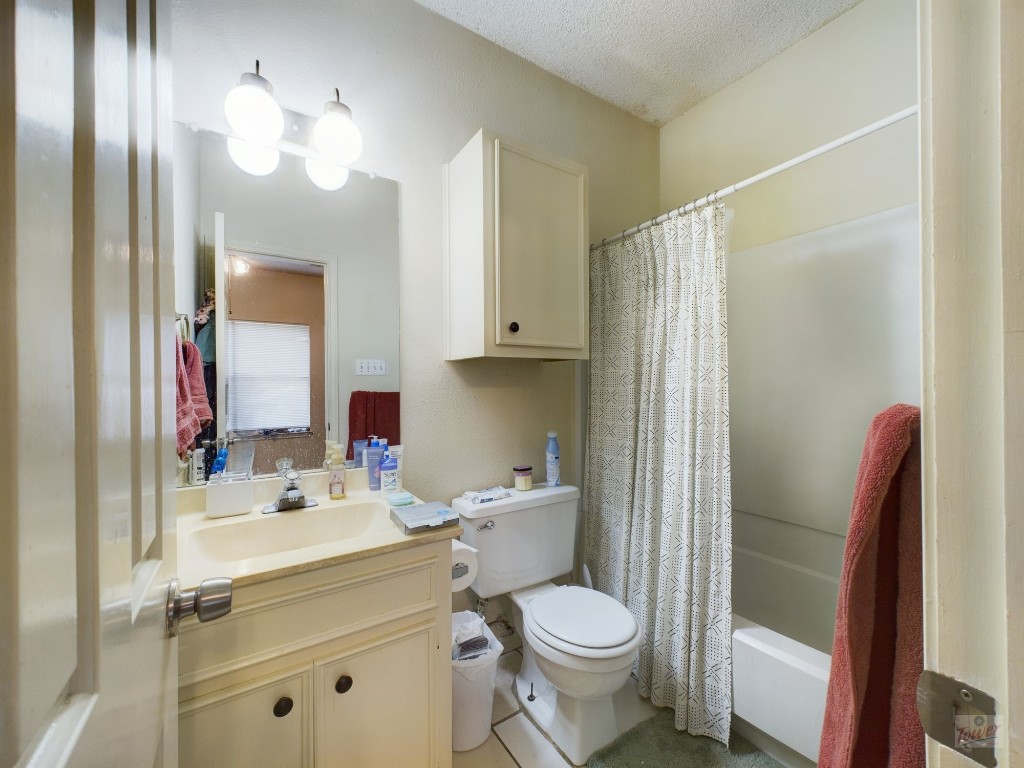 4111 Speedway, Unit 2 Austin, TX 78751 - Photo 3 of 14 a bathroom with a sink toilet vanity and shower