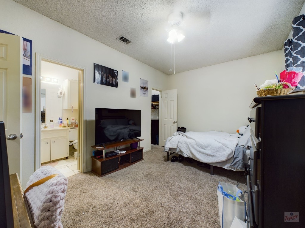 4111 Speedway, Unit 2 Austin, TX 78751 - Photo 10 of 14 a bedroom with a bed and flat tv screen