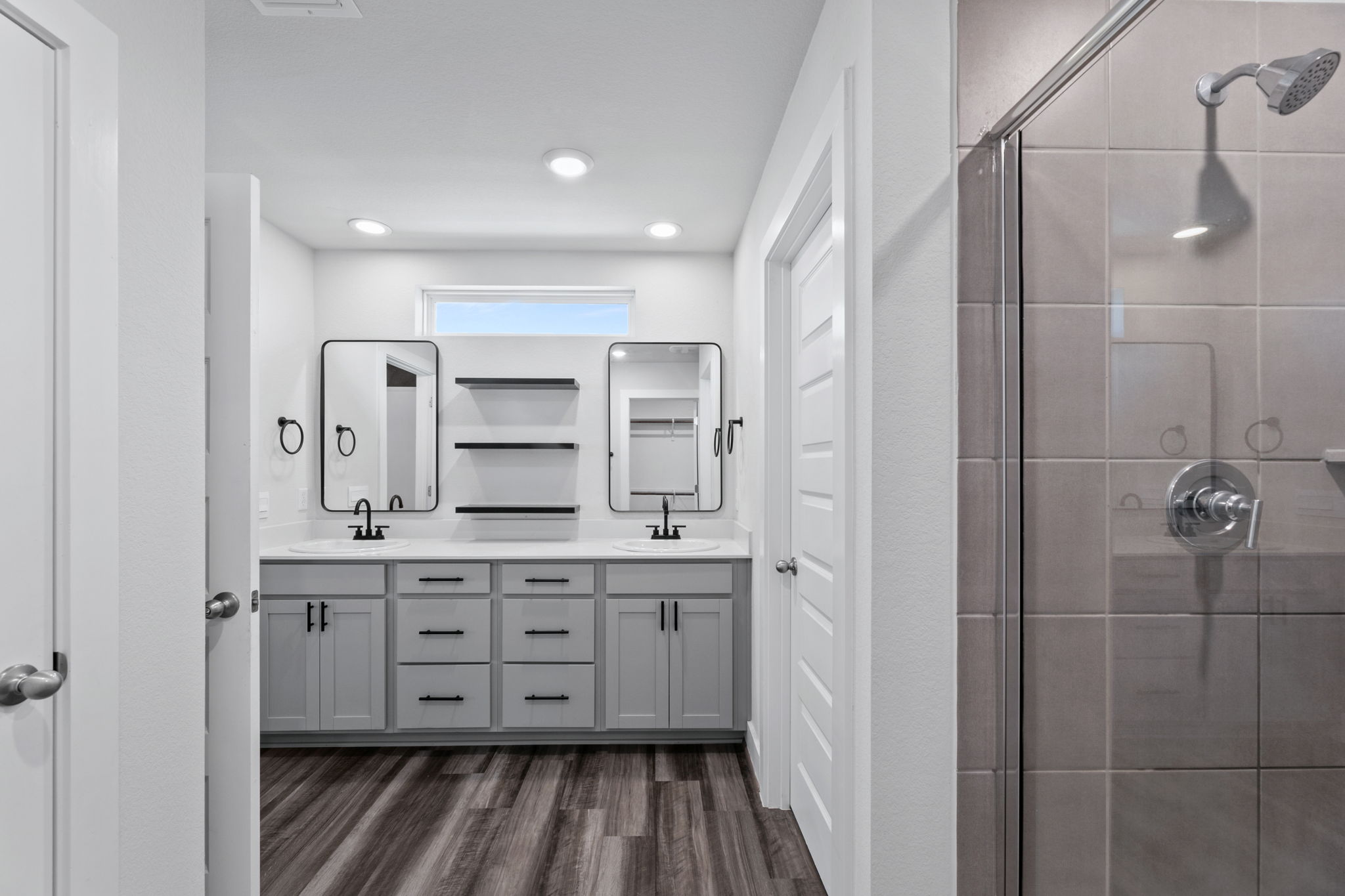 7312 Travertine Spring Drive Austin, TX 78744 - Photo 19 of 32 Dual vanity with sleek, modern mirrors and ample storage for all your essentials.