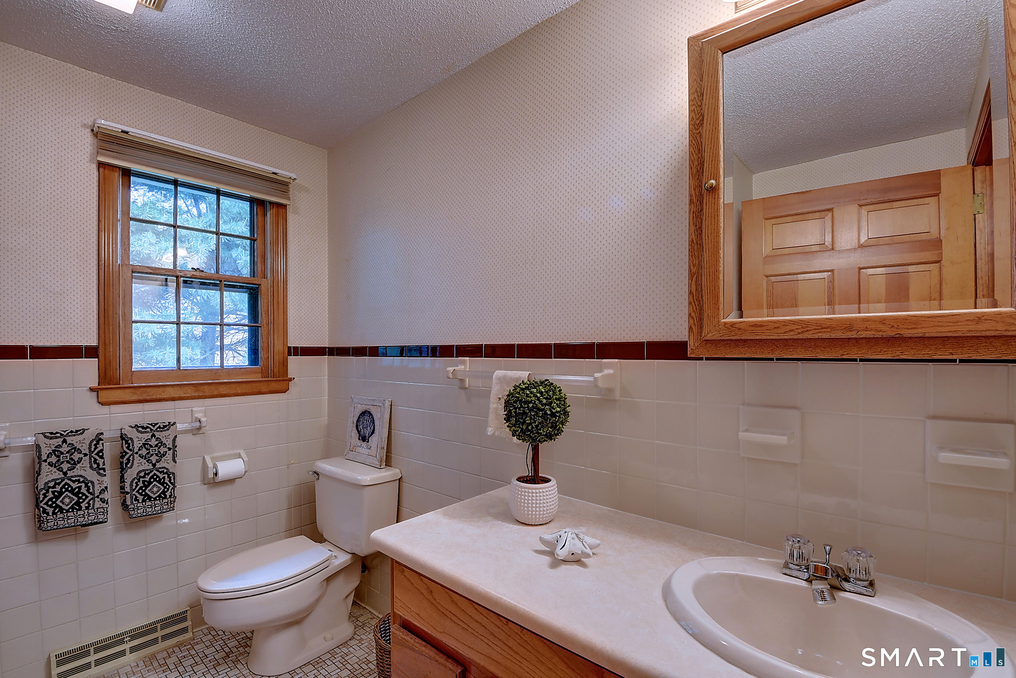 80 Grist Mill Road Wethersfield, CT 06109 - Photo 31 of 40 a bathroom with a toilet sink and mirror