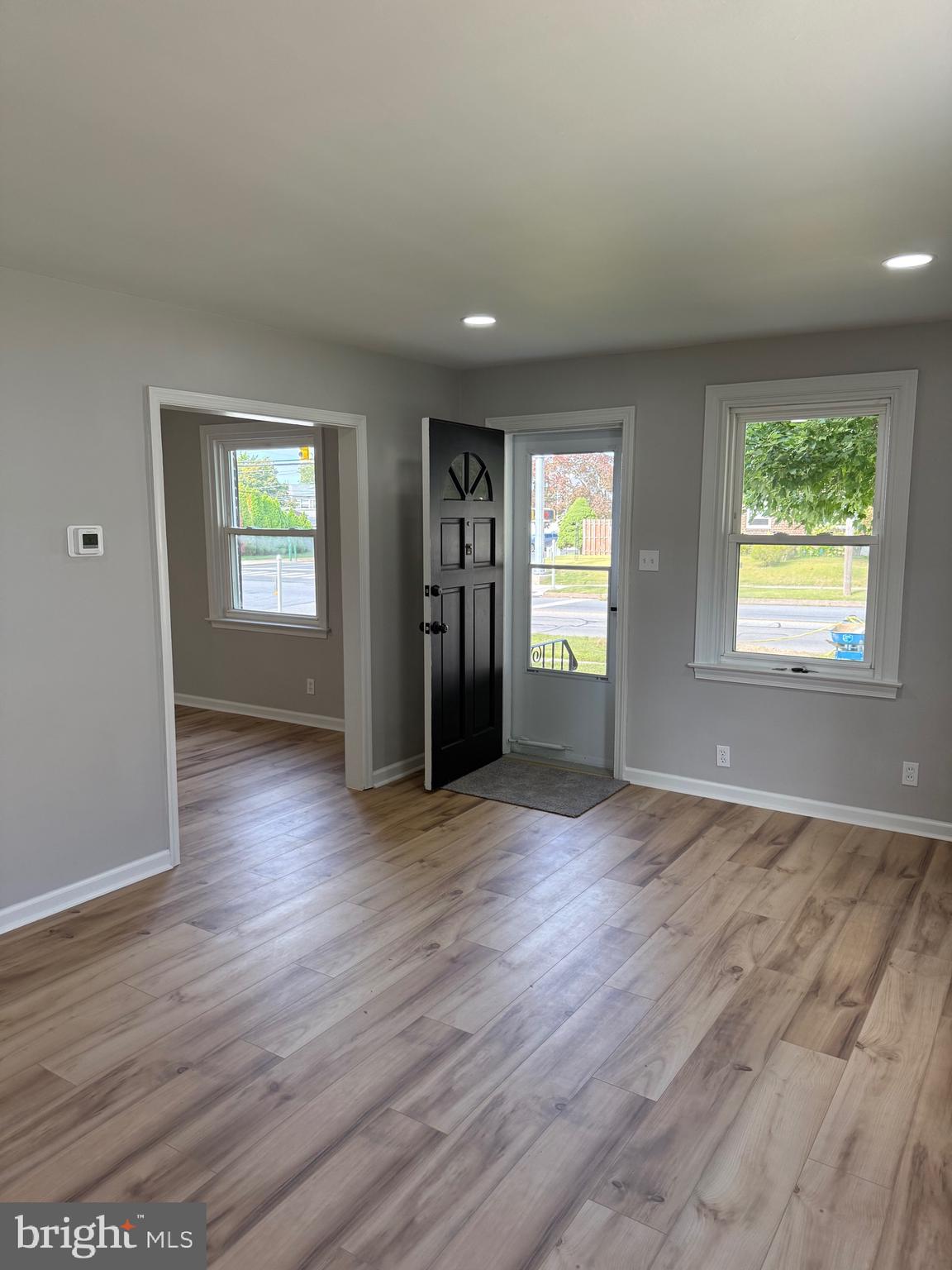 802 Fairview Road Swarthmore, PA 19081 - Photo 3 of 18 an empty room with wooden floor and windows