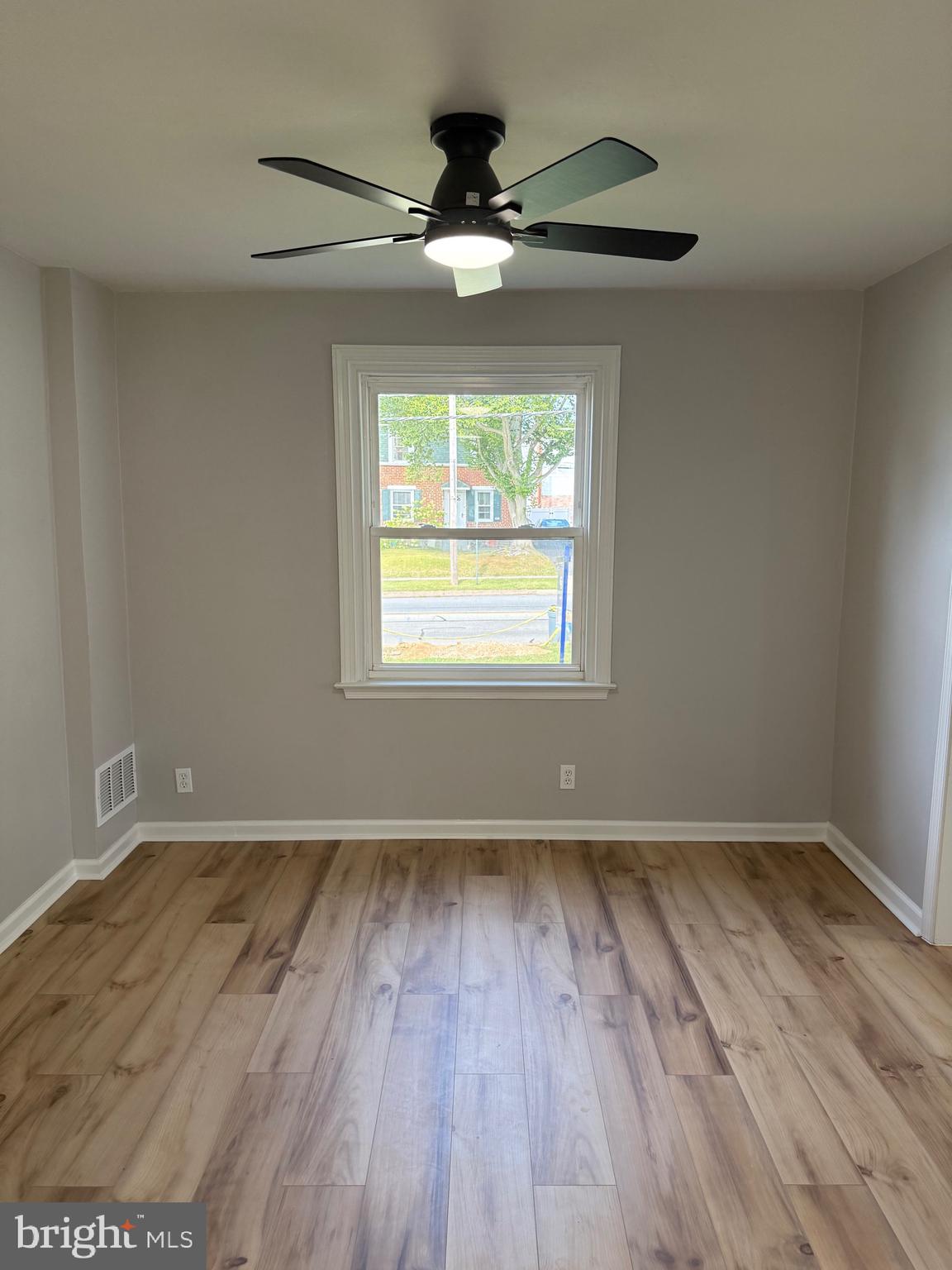 802 Fairview Road Swarthmore, PA 19081 - Photo 6 of 18 a view of an empty room with wooden floor and a window