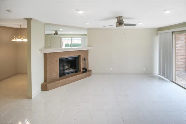 an empty room with fireplace and windows
