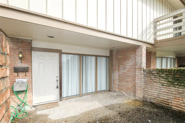 a front view of a building with a garden