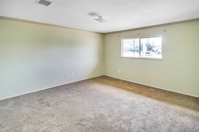 an empty room with a empty space and windows