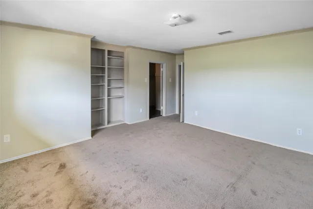 a view of an empty room with a closet