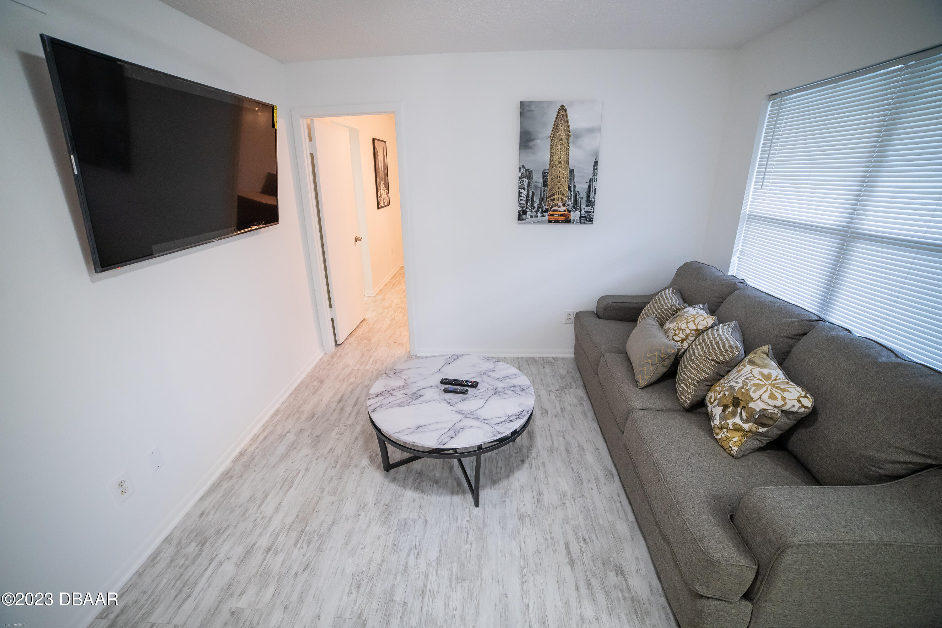 1600 Big Tree Road, Unit A7 South Daytona, FL 32119 - Photo 3 of 5 a living room with furniture and a flat screen tv