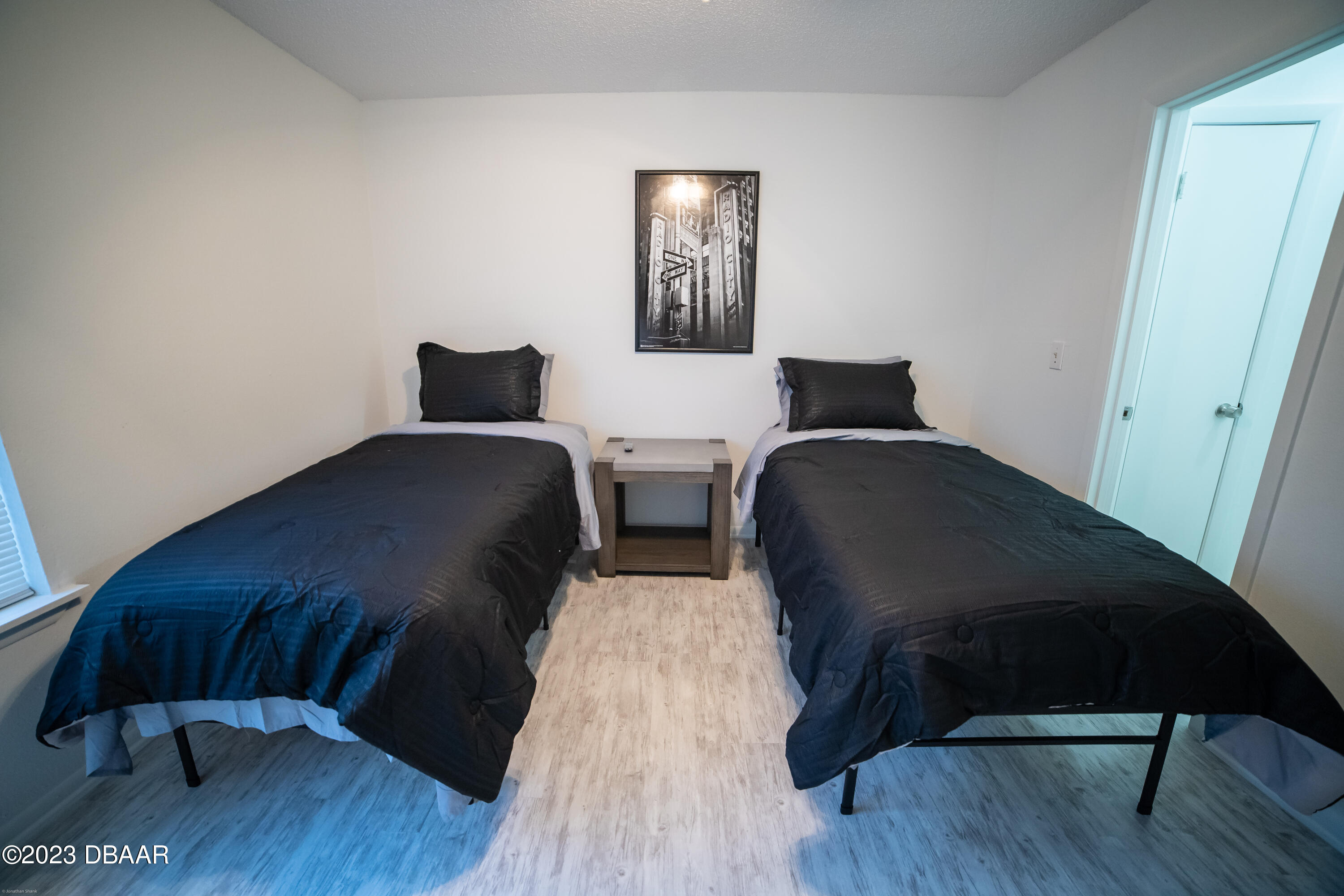 1600 Big Tree Road, Unit A7 South Daytona, FL 32119 - Photo 4 of 5 a bedroom with two beds and wooden floor