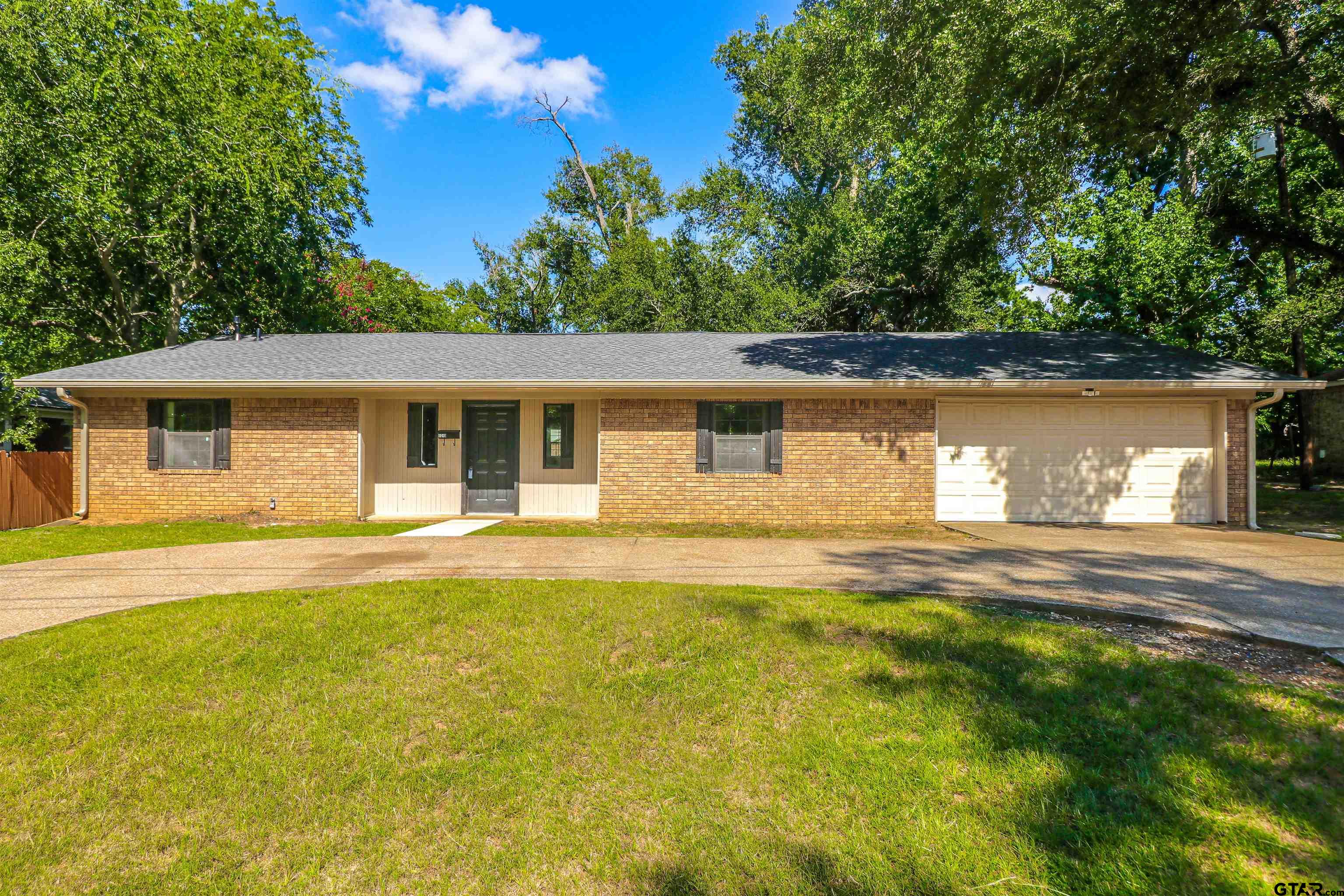 a view of a house with pool and a yard