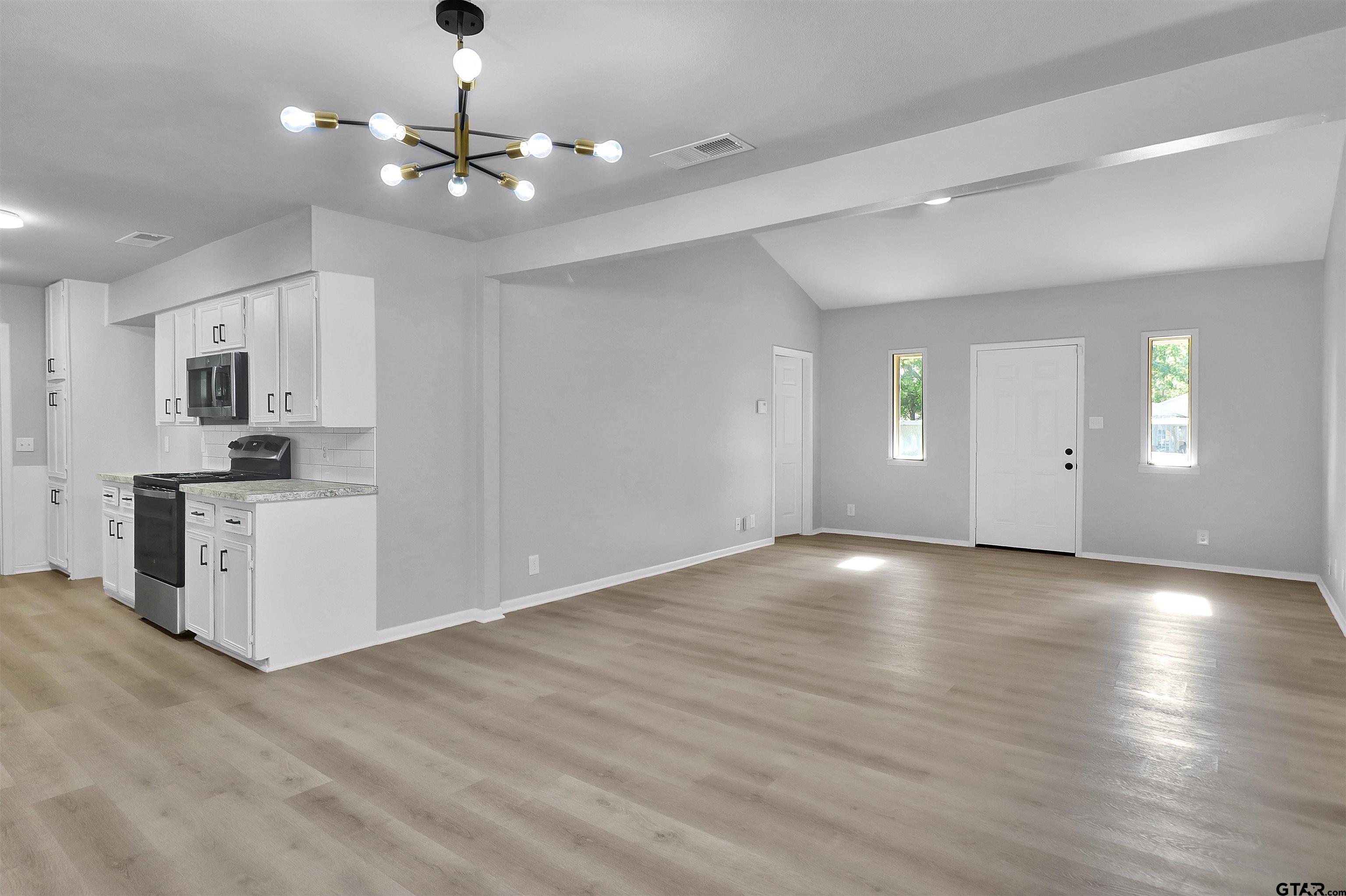 1310 Ridgeview Drive Tyler, TX 75701 - Photo 13 of 30 a view of an empty room with window and wooden floor