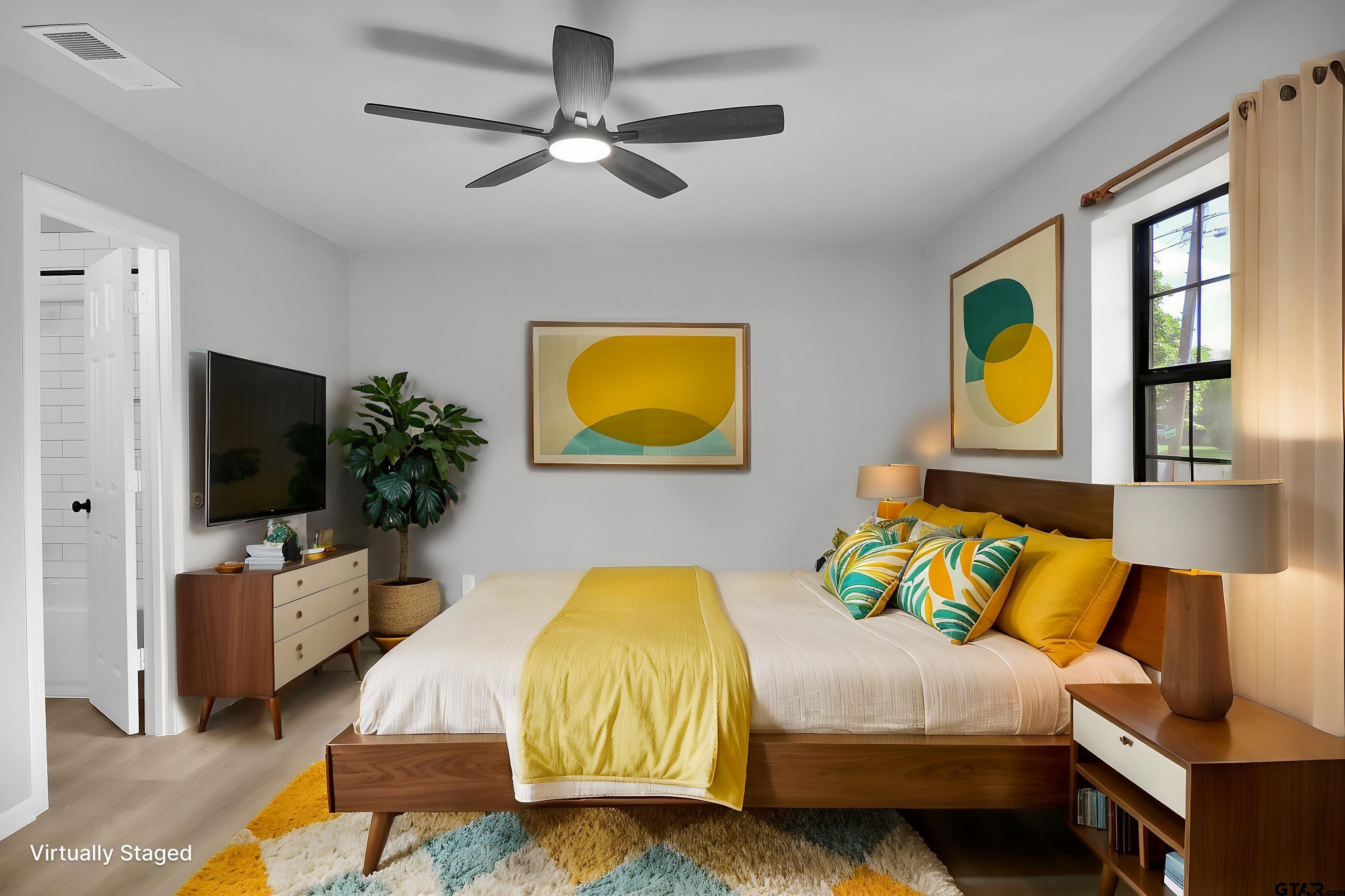 1310 Ridgeview Drive Tyler, TX 75701 - Photo 17 of 30 a bedroom with a bed and a flat screen tv