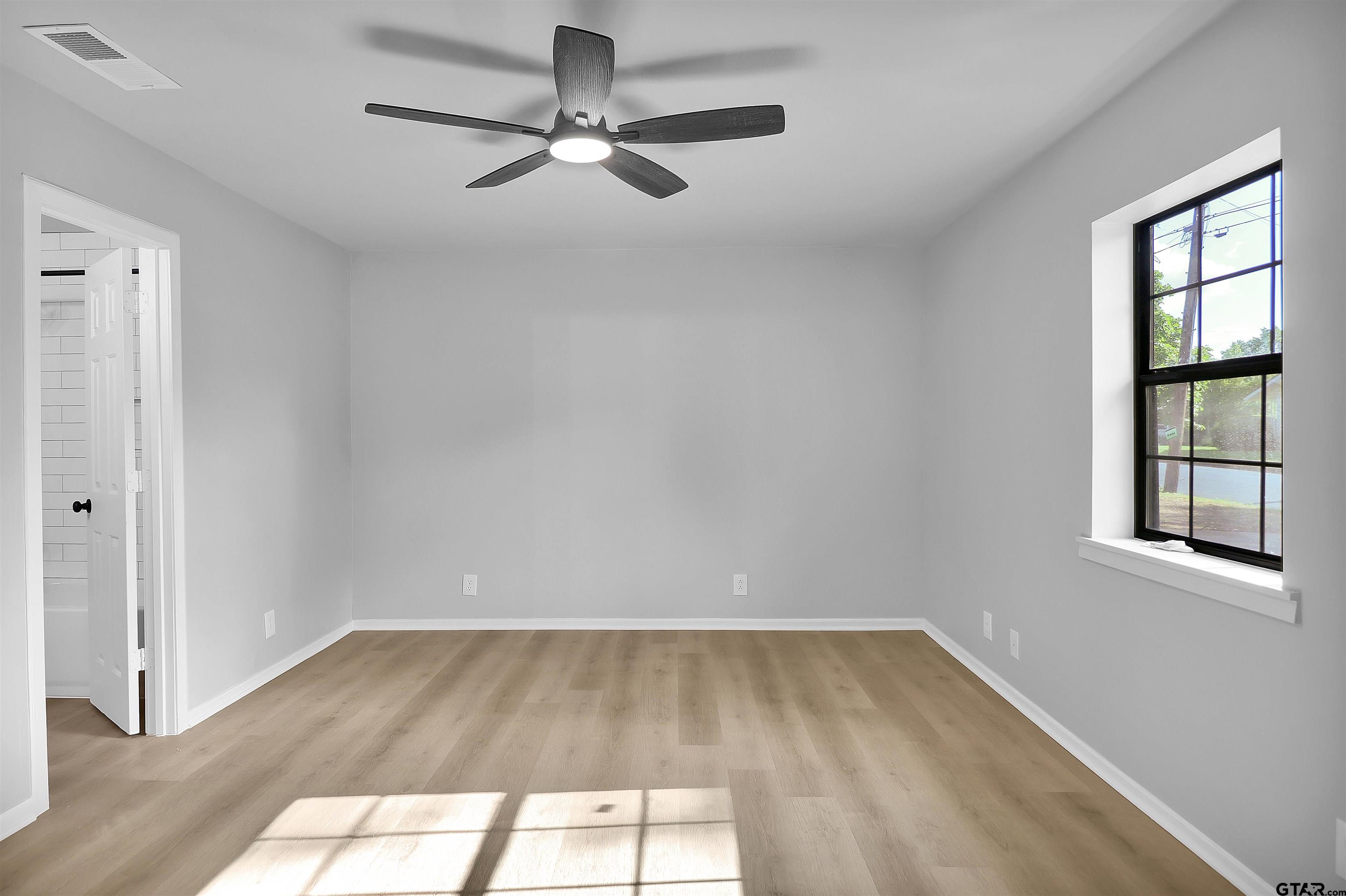 1310 Ridgeview Drive Tyler, TX 75701 - Photo 18 of 30 wooden floor in an empty room with a window