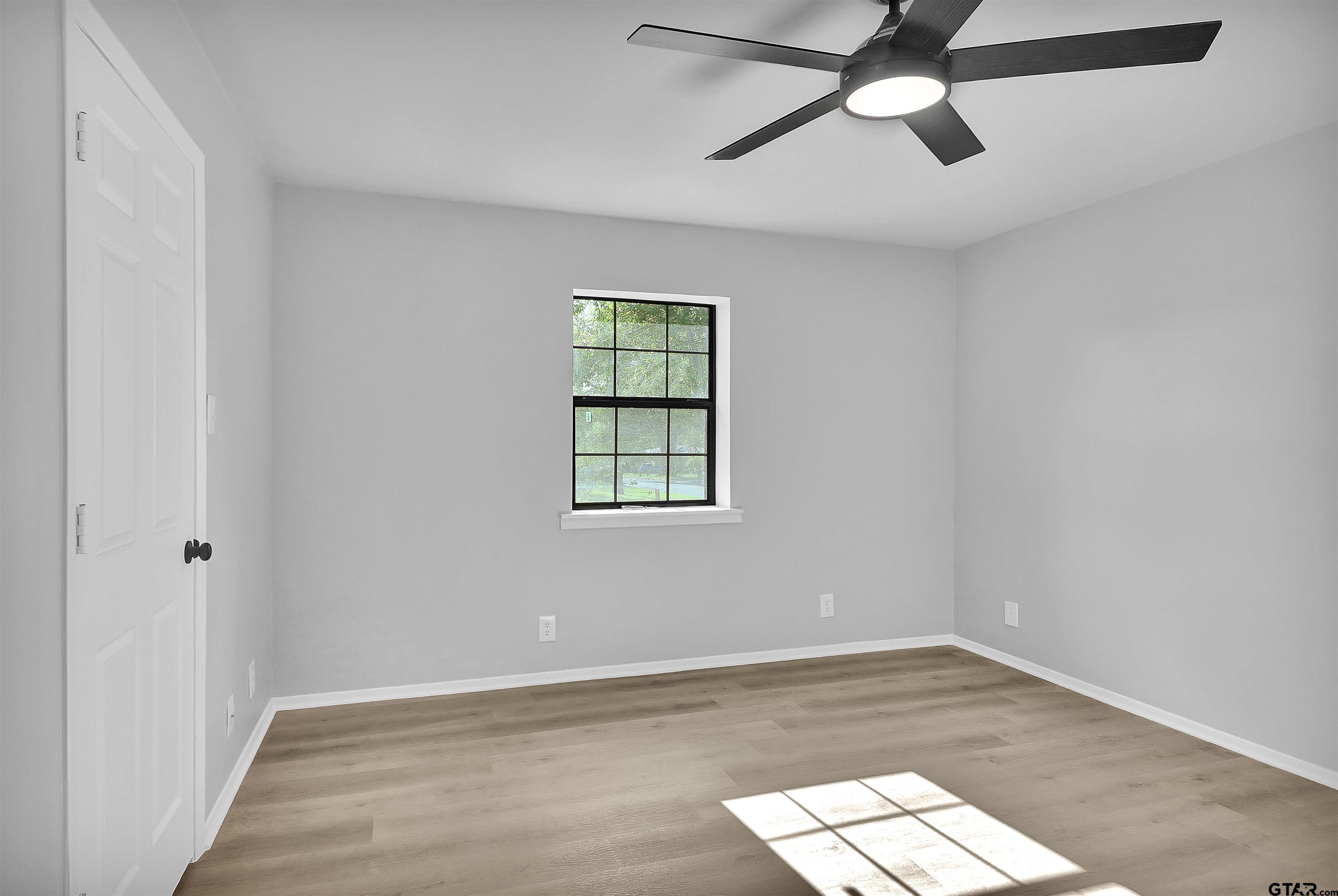1310 Ridgeview Drive Tyler, TX 75701 - Photo 22 of 30 an empty room with wooden floor closet and windows