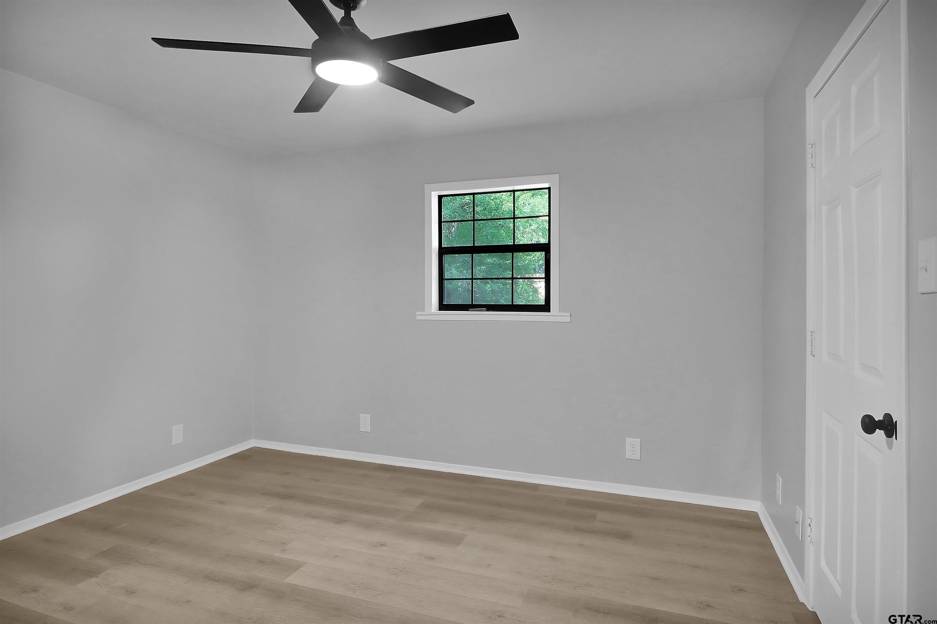 1310 Ridgeview Drive Tyler, TX 75701 - Photo 23 of 30 wooden floor in an empty room with a window