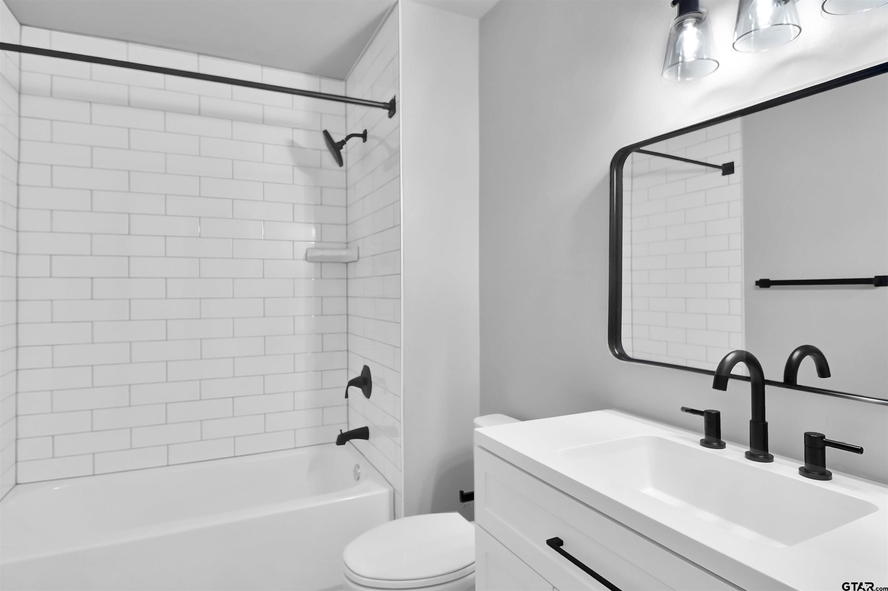 1310 Ridgeview Drive Tyler, TX 75701 - Photo 24 of 30 a bathroom with a sink toilet and shower